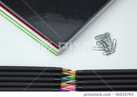 set of school tools with colored self-tips pens, clips and notebooks on white background set of school tools with colored self-tips pens, clips and notebooks on white background 96830765