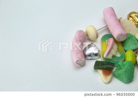 close-up of pile of sweets on white background with copy space 96830800
