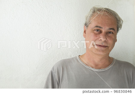 mature man looking straight ahead on white background with happy expression 96830846