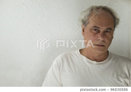close-up of mature man with grey hair in white shirt on a white background 96830886