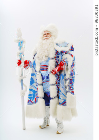 a male actor in a blue traditional Father Frost costume on a white background. a male actor in a blue traditional Father Frost costume on a white background. 96830891