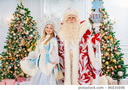 a Father Frost and Snow Maiden in the room with christmas trees a Father Frost and Snow Maiden in the room with christmas trees 96830896