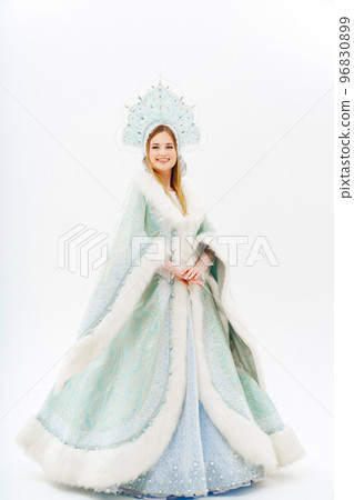 Snow Maiden in a traditional costume with a kokoshnik on a white background. Snow Maiden in a traditional costume with a kokoshnik on a white background. 96830899
