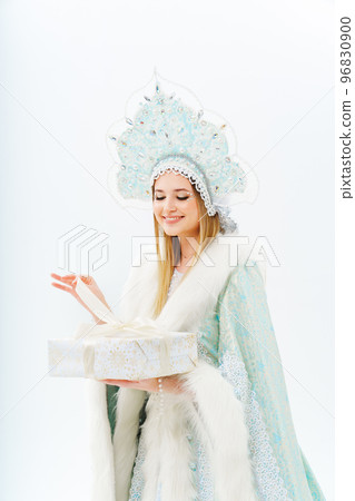 portrait of Snow Maiden in a costume with a kokoshnik with gift box on a white. 96830900