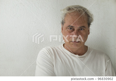 close-up of mature man with grey hair and white shirt looking at camera on white background 96830902