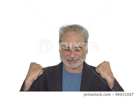 foreground portrait of a mature man with a beard celebrating with fist raised on a white background 96831087