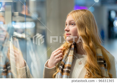 Shopping. A young girl looks at shop window. Shopping. A young girl looks at shop window. 96831365