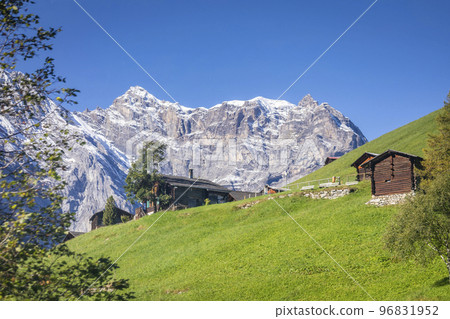 Snowcapped Bernese Swiss alps and alpine farms, Switzerland Snowcapped Bernese Swiss alps and alpine farms, Switzerland 96831952