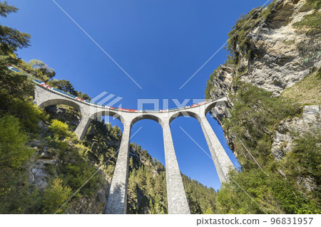 Swiss train over Landwasser Viaduct bridge in the alps, Graubunden, Switzerland 96831957