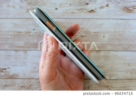 Hand holding a stylish Aiphone smartphone case 96834718