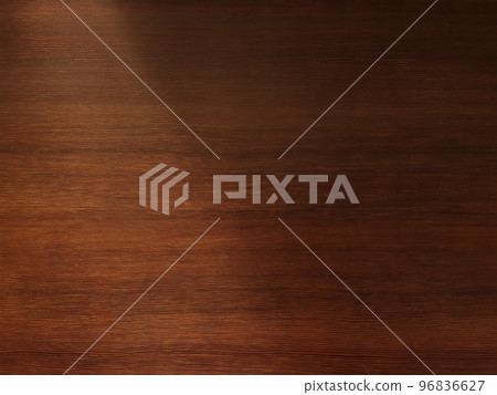 A background image of a delicate brown wood grain desk board with light obliquely from the upper left 96836627