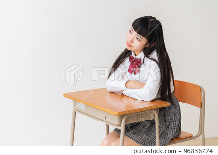 Female student in uniform thinking classroom 96836774