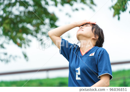 A Japanese woman who is a soccer fan or supporter and is shocked when she loses a goal while watching a soccer game A Japanese woman who is a soccer fan or supporter and is shocked when she loses a goal while watching a soccer game 96836851