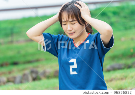 A Japanese woman who is a soccer fan or supporter and is shocked when she loses a goal while watching a soccer game A Japanese woman who is a soccer fan or supporter and is shocked when she loses a goal while watching a soccer game 96836852