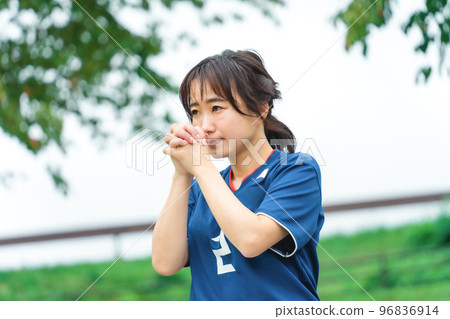 A Japanese woman who is a soccer fan and supporter cheering for the Japan national team as if praying A Japanese woman who is a soccer fan and supporter cheering for the Japan national team as if praying 96836914