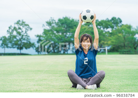 A Japanese woman who is a soccer fan and supporter with a soccer ball on the playground A Japanese woman who is a soccer fan and supporter with a soccer ball on the playground 96838784