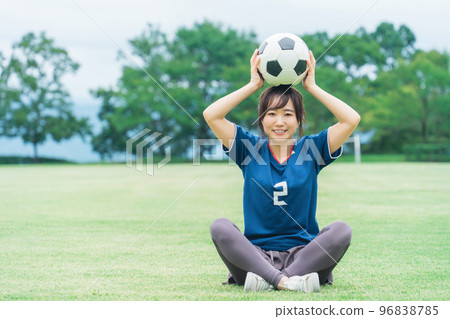 A Japanese woman who is a soccer fan and supporter with a soccer ball on the playground A Japanese woman who is a soccer fan and supporter with a soccer ball on the playground 96838785