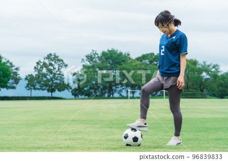 A Japanese woman wearing a uniform on a soccer field and practicing soccer and futsal 96839833