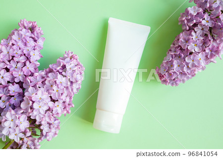 White squeeze bottle cosmetic tube pack and lilac flowers on green background. Mockup. Daily cream, gel, skin care, sunscreen, moisturizer, toothpaste. Front top view, blank tube, template, flat lay White squeeze bottle cosmetic tube pack and lilac flowers on green background. Mockup. Daily cream, gel, skin care, sunscreen, moisturizer, toothpaste. Front top view, blank tube, template, flat lay 96841054