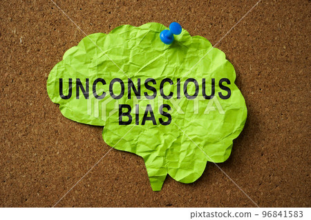 Brain made of paper with the inscription Unconscious Bias pinned to the board. 96841583