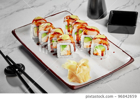 Sushi rolls with cream cheese, avocado, tobiko, butterfish, mayonnaise and unagi sauce Sushi rolls with cream cheese, avocado, tobiko, butterfish, mayonnaise and unagi sauce 96842659
