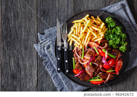 Lomo saltado, fried beef, french fries, veggies 96842672