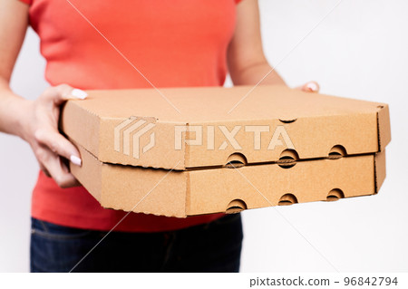 Girl delivering pizza in cardboard boxes on a white background 96842794