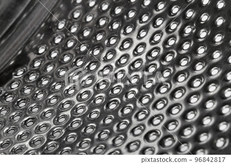 Close-up of inside of a steel washing machine drum Close-up of inside of a steel washing machine drum 96842817