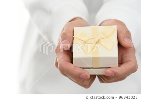 Young man presenting a wrapped gift box 96843023