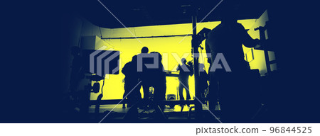 Behind the scenes of shooting video production and lighting set for filming movie which film crew team working in silhouette and professional equipment in studio for video online. video production 96844525