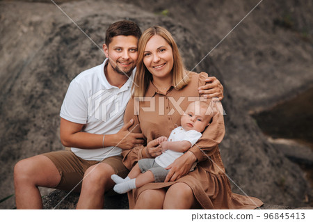 Happy family of three in the summer in the park in nature 96845413