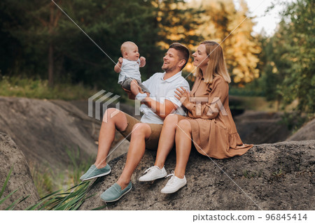 Happy family of three in the summer in the park in nature 96845414
