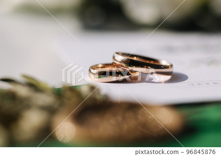 Macro photo of wedding rings on oaths Macro photo of wedding rings on oaths 96845876