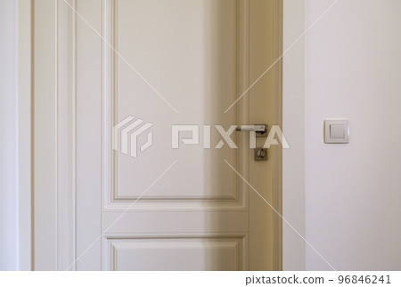 fragment of an open door with a lock and handle, interior in pastel colors 96846241