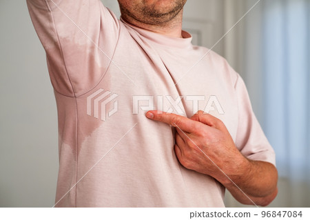 Man with hyperhidrosis sweating very badly under armpit Man with hyperhidrosis sweating very badly under armpit 96847084