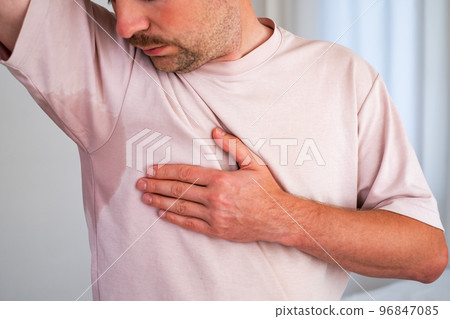 Man with hyperhidrosis sweating very badly under armpit Man with hyperhidrosis sweating very badly under armpit 96847085
