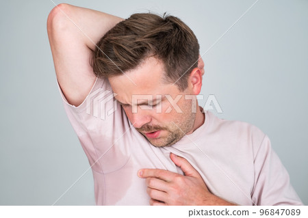 Man with hyperhidrosis sweating very badly under armpit 96847089