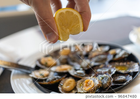limpets sea fruits grilled on rustic frying pan limpets sea fruits grilled on rustic frying pan 96847480