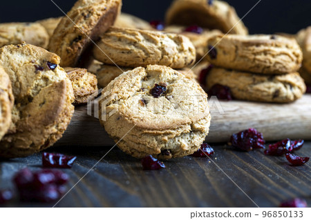 delicious dried cookies made of high-quality flour with dried red cranberries on the table delicious dried cookies made of high-quality flour with dried red cranberries on the table 96850133