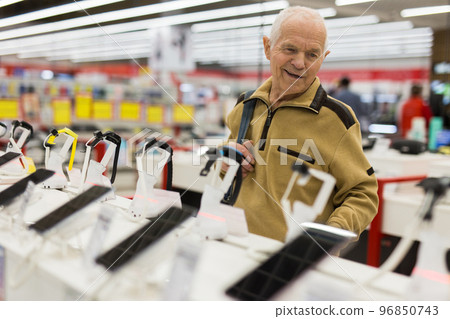 senor man pensioner buying modern smart watch in showroom of digital electronic goods store 96850743
