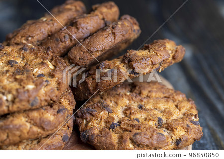 Delicious cookies with pieces of chocolate on the table 96850850