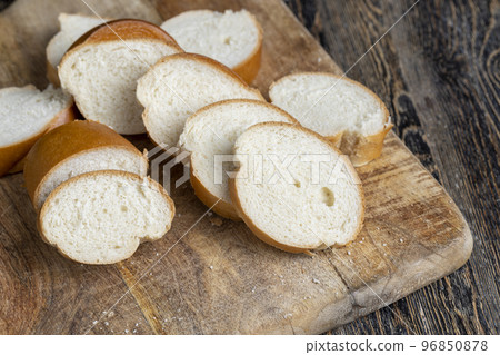 Sliced wheat loaf on the table 96850878