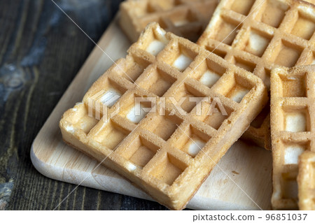 square sweet soft waffles on the table 96851037