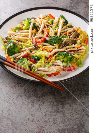 Stir Fried vegetables carrots, peppers, cabbage, broccoli and shimeji beech mushrooms close-up in a plate. Vertical Stir Fried vegetables carrots, peppers, cabbage, broccoli and shimeji beech mushrooms close-up in a plate. Vertical 96851578
