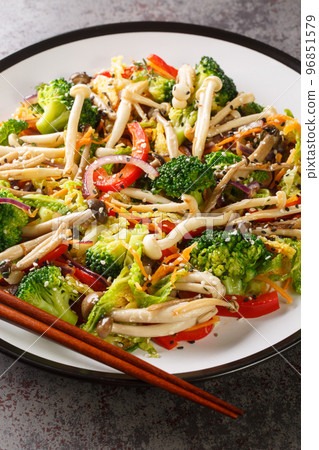 plate of stir fried vegetables with shimeji beech mushrooms closeup. Vertical plate of stir fried vegetables with shimeji beech mushrooms closeup. Vertical 96851579