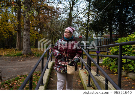 40 yo white woman with Down Syndrome, wearing winter clothers walking down and isle outdoors, Tienen, belgium 40 yo white woman with Down Syndrome, wearing winter clothers walking down and isle outdoors, Tienen, belgium 96851640