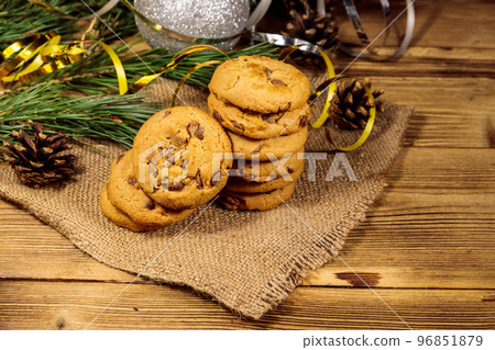 Chocolate chip cookies with Christmas decoration on wooden table Chocolate chip cookies with Christmas decoration on wooden table 96851879