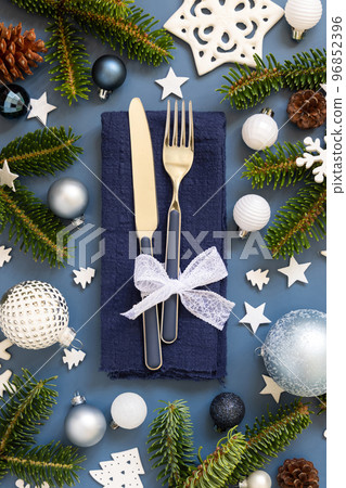Blue and white Christmas table setting with decorations and fir tree branches top view 96852396