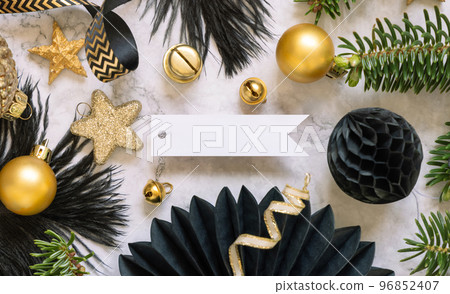 Blank horizontal gift tag between black and golden Christmas decorations, top view, Mockup Blank horizontal gift tag between black and golden Christmas decorations, top view, Mockup 96852407