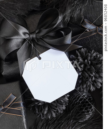 Wrapped Gift Boxes with black paper flowers and decorations and square gift tag, mockup Wrapped Gift Boxes with black paper flowers and decorations and square gift tag, mockup 96852408